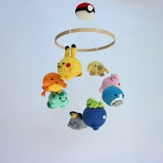 a crocheted mobile with pokemon stuffed animals hanging from it