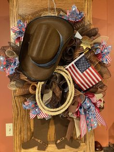 a cowboy's hat is hanging on the front door with american flags and other decorations