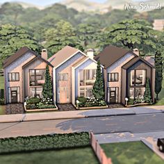 a group of houses sitting on top of a lush green field