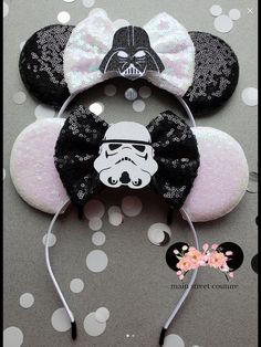 star wars mickey mouse ears with a darth vader helmet on top and a bow at the bottom