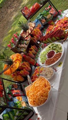 a table full of different types of food on display at an outdoor event or gathering