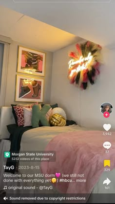 a bed room with a neatly made bed next to a wall mounted clock and pictures on the wall