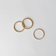 This is our By Brockton house twist ring in solid 14k yellow gold. The wire is handmade and hand twisted to order in a small Toronto workshop. We love it because it is so versatile. It looks great on its own and pairs nicely with an engagement ring or classic ring stack. Available in 1.5 mm and 2.0 mm widths. MATERIALS 14k yellow gold. SIZE The ring will be custom made in your size. Size 6 ring is in-stock and available and ready to ship immediately. Additional fee may apply for larger sizes. Please let us know your size when ordering. MAKE TIME It takes approximately 3 weeks to custom make your ring. Gold Spiral Minimalist Stackable Rings, Handmade 14k Yellow Gold Stackable Rings, Yellow Gold Twisted Stackable Jewelry, Yellow Gold Twisted Ring For Gift, Twisted Yellow Gold Ring For Gift, Twisted Yellow Gold Ring As Gift, Minimalist Twisted Yellow Gold Jewelry, Twisted 14k Yellow Gold Rings, Everyday Gold Wire Wrapped Rings