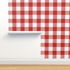 a red and white checkered wallpaper in an empty room