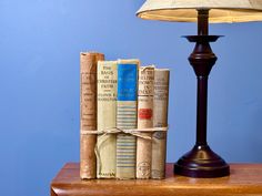 three books are stacked on top of each other in front of a lampshade