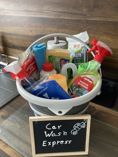 a bucket filled with cleaning products next to a sign