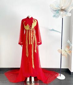 Handmade red bridal Ao Dai with finest Phoenix embroidery by yours truly.  Color :  Red and gold embroidery  Details:  Traditional Vietnamese Ao Dai jacket  Flares Long sleeves  Front closing with button  Cathedral length  Shop other AO DAI: https://etsy.me/3E9ppC7 Turnaround time: Due to the delicate nature of the handcrafted goods we produce this beautiful dress has creation time of approximately 6-10 weeks  Estimated shipping times : ✅Standard shipping: 3-6 weeks for most countries  ✅Expedite Red Floor-length Gown For Traditional Ceremonies, Red Floral Embroidered Dresses With Traditional Drape, Red Dresses With Floral Embroidery And Traditional Drape, Traditional Red Long Sleeve Gown, Traditional Long Sleeve Red Gown, Traditional Red Gown With Long Sleeves, Traditional Red Gown With Floral Embroidery, Ceremonial Red Dress With Traditional Drape, Red Long Sleeve Gown For Ceremonies