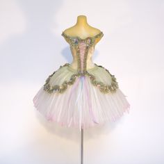 a white and pink tutu dress on a mannequin headdress with beadings