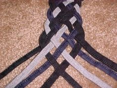 a tie that is on top of a brown carpet with black, white and grey stripes