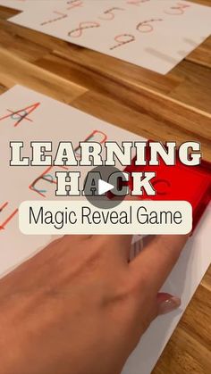 a person is writing on paper with the words learning hack and magic reveal game in front of them