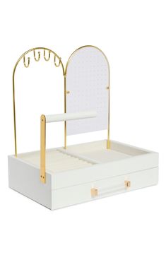 a white box with a mirror and gold handles