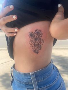 a woman's stomach with flowers on it and the bottom part of her belly