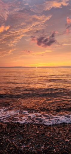 the sun is setting over the water at the beach