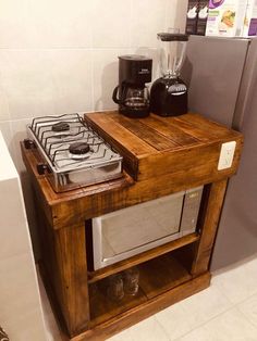 a small wooden table with a microwave and coffee maker on it