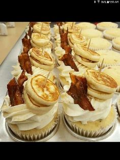 cupcakes with bacon on them are lined up