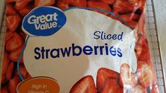 a bag of sliced strawberries sitting on top of a counter