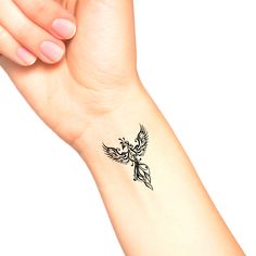 a woman's arm with a small tattoo design on the left side of her wrist