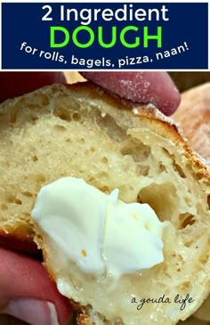 a close up of a person holding a piece of bread with whipped cream on it