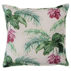 a white pillow with pink and green tropical leaves on the front, along with a red flower