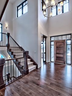 a large open floor plan with stairs and windows