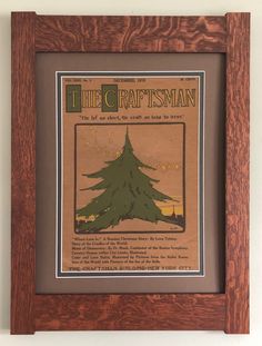 a wooden frame with a christmas tree on the front and bottom, framed in wood