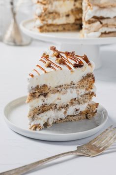 a piece of cake on a plate with a fork next to it and another slice in the background