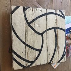 a piece of wood that has been painted with black and white lines