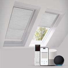 an appliance in the corner of a room with two skylights