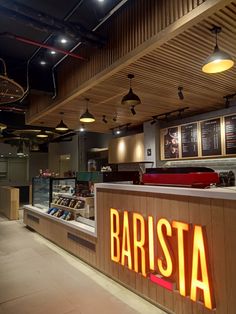 the interior of a fast food restaurant with neon signs on the wall and lights hanging from the ceiling