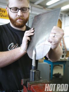 a man working on a piece of metal