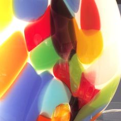 a colorful glass sculpture sitting on top of a table