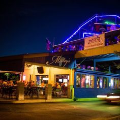 the outside of a restaurant lit up at night