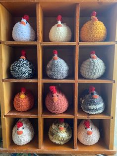 several crocheted chickens sitting on top of wooden shelves