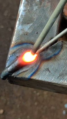 a piece of metal that is being worked on by a person with an electric tool