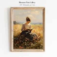 a painting of a woman sitting in a field reading a book with the words blossom print gallery printed on it