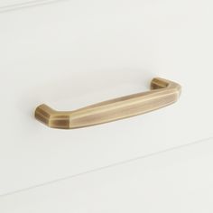 a close up of a door handle on a white surface