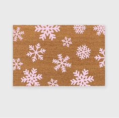 a brown rug with pink snowflakes on it