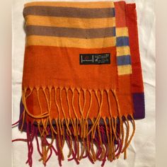 Fraas Cashmink Scarf. Oversized With A Red, Orange, Yellow, Blue, And Purple Pattern. Perfect For Men, Women, Or Children. Measurements: 14” Wide, 72” Long (Without Fringe). Made In Germany And Exclusive To Fraas. Cashmink Yarn Is 20% Finer Than Cashmere, Making It Incomparably Soft Against The Skin, Pleasantly Warming, Also Hypo-Allergenic, And Water Repellent. Condition: Never Worn. Any Defects Are Due To Camera, Not The Garment Itself. Smoke Free Home. No Perfume/Cologne Or Scented Laundry Pr Laundry Products, Red Orange Yellow, Purple Pattern, Orange Yellow, Yellow Blue, Repellent, Water Repellent, Scarf Wrap, Scarf Accessory