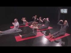 a group of people doing yoga poses on red mats