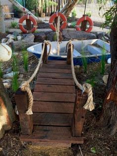 a wooden bridge that has rope on it