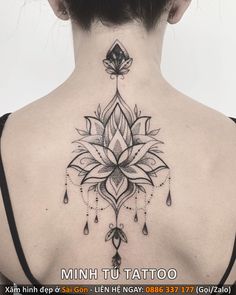 the back of a woman's neck with a tattoo on it