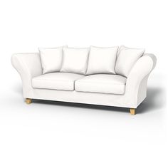 a white couch sitting on top of a white floor