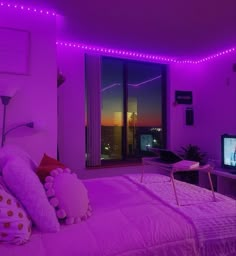 a bedroom with purple lighting and a bed in the corner, tv on top of it