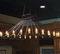 a chandelier with many lit candles hanging from it