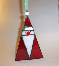 a stained glass christmas tree ornament hanging on a wall