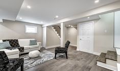 a living room filled with furniture and a flat screen tv on top of a hard wood floor