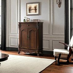 a living room scene with focus on the armoire