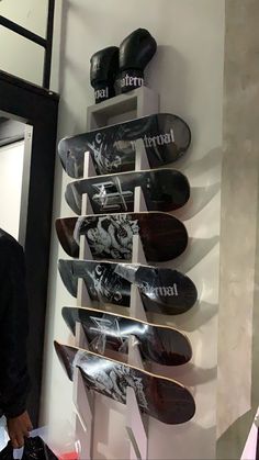 a man standing in front of a display of skateboards