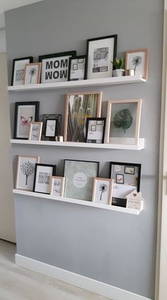 the shelves are filled with pictures and framed photographs