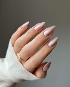 a woman's hand with pink and white manies on it, wearing a gold ring